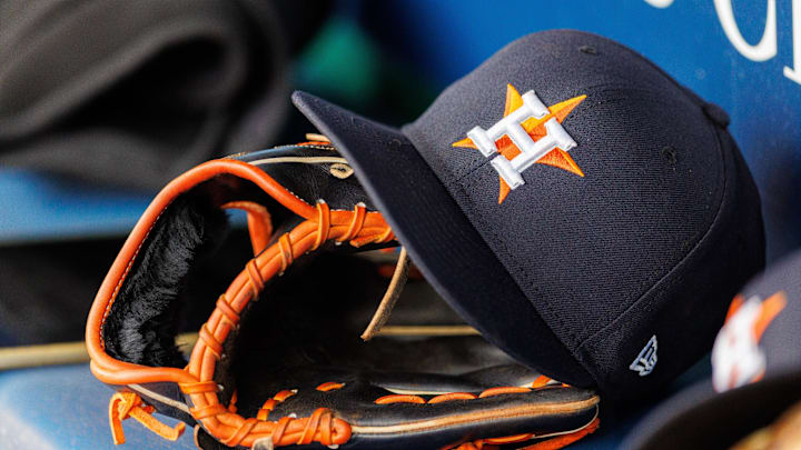 Apr 27, 2025; Kansas City, Missouri, USA; Houston Astros hat and glove in the dugout during the second inning against the Kansas City Royals at Kauffman Stadium. 