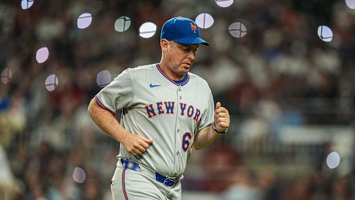 Aug 23, 2025; Cumberland, Georgia, USA; New York Mets manager Carlos Mendoza (64) on the field during the game against the Atlanta Braves during the seventh inning at Truist Park. Mandatory Credit: Dale Zanine-Imagn Images
