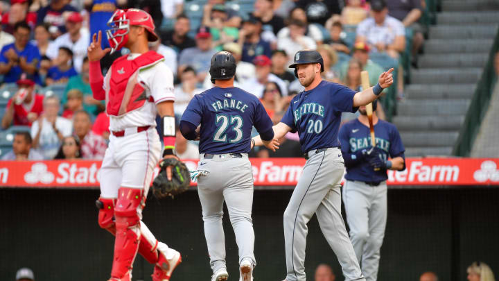 Seattle Mariners first baseman Ty France (23) is greeted by right fielder Luke Raley (20) after scoring a run against the Los Angeles Angels.