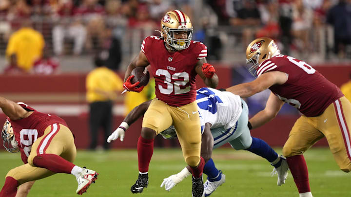 Oct 8, 2023; Santa Clara, California, USA; San Francisco 49ers running back Tyrion Davis-Price (32) carries the ball against Dallas Cowboys linebacker Malik Jefferson (46) as offensive tackle Colton McKivitz (right) blocks during the fourth quarter at Levi's Stadium. Mandatory Credit: Darren Yamashita-Imagn Images