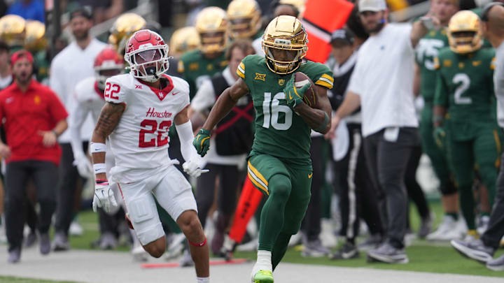 Nov 29, 2025; Waco, Texas, USA;  Baylor Bears wide receiver Kobe Prentice (16) makes a catch ahead of Houston Cougars defensive back Marc Stampley II (22) during the second half at McLane Stadium. Mandatory Credit: Chris Jones-Imagn Images