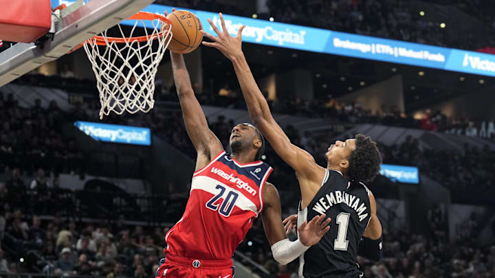 Nov 13, 2024; San Antonio, Texas, USA; Washington Wizards forward Alex Sarr (20) goes up to dunk while defended by San Antonio Spurs center Victor Wembanyama (1) during the second half at Frost Bank Center. Mandatory Credit: Scott Wachter-Imagn Images