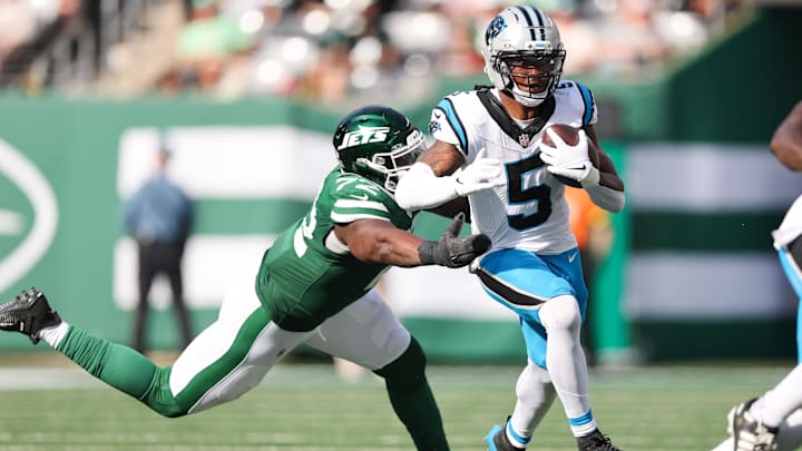 Carolina Panthers RB Rico Dowdle runs with the ball while being defended by New York Jets DT Micheal Clemons. Carolina Panthers RB Rico Dowdle runs with the ball while being defended by New York Jets DT Micheal Clemons.