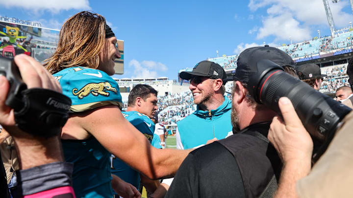 Sep 21, 2025; Jacksonville, Florida, USA; Jacksonville Jaguars head coach Liam Coen and quarterback Trevor Lawrence (16) shake hands after the game at EverBank Stadium. Mandatory Credit: Morgan Tencza-Imagn Images