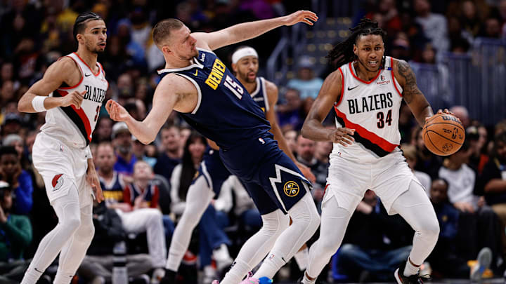 Feb 12, 2025; Denver, Colorado, USA; Portland Trail Blazers forward Jabari Walker (34) grabs a loose ball against Denver Nuggets center Nikola Jokic (15) as forward Toumani Camara (33) defends in the second quarter at Ball Arena. Mandatory Credit: Isaiah J. Downing-Imagn Images Feb 12, 2025; Denver, Colorado, USA; Portland Trail Blazers forward Jabari Walker (34) grabs a loose ball against Denver Nuggets center Nikola Jokic (15) as forward Toumani Camara (33) defends in the second quarter at Ball Arena. Mandatory Credit: Isaiah J. Downing-Imagn Images