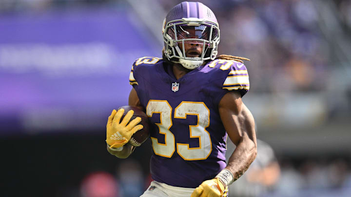 Sep 22, 2024; Minneapolis, Minnesota, USA; Minnesota Vikings running back Aaron Jones (33) runs the ball against the Houston Texans during the fourth quarter at U.S. Bank Stadium. Mandatory Credit: Jeffrey Becker-Imagn Images