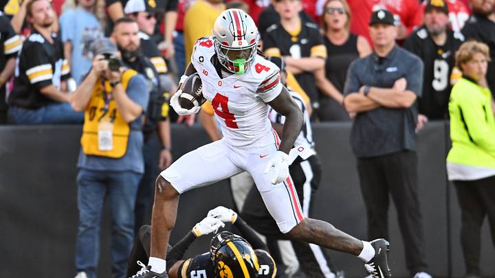 Oct 3, 2026; Iowa City, Iowa, USA; Ohio State Buckeyes wide receiver Jeremiah Smith (4) runs over Iowa Hawkeyes defensive back Anthony Hawkins (5) during the second half at Kinnick Stadium. Mandatory Credit: Jeffrey Becker-Imagn Images Oct 3, 2026; Iowa City, Iowa, USA; Ohio State Buckeyes wide receiver Jeremiah Smith (4) runs over Iowa Hawkeyes defensive back Anthony Hawkins (5) during the second half at Kinnick Stadium. Mandatory Credit: Jeffrey Becker-Imagn Images