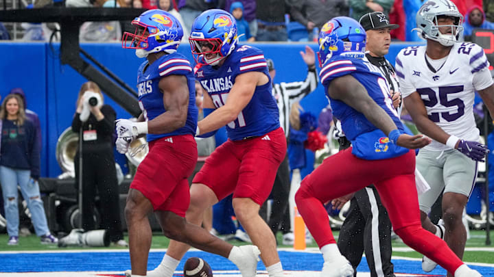 Oct 25, 2025; Lawrence, Kansas, USA; Kansas Jayhawks running back Daniel Hishaw Jr. (9) celebrates with team mates against the Kansas State Wildcats after scoring during the first half of the game at David Booth Kansas Memorial Stadium. Mandatory Credit: Denny Medley-Imagn Images Oct 25, 2025; Lawrence, Kansas, USA; Kansas Jayhawks running back Daniel Hishaw Jr. (9) celebrates with team mates against the Kansas State Wildcats after scoring during the first half of the game at David Booth Kansas Memorial Stadium. Mandatory Credit: Denny Medley-Imagn Images
