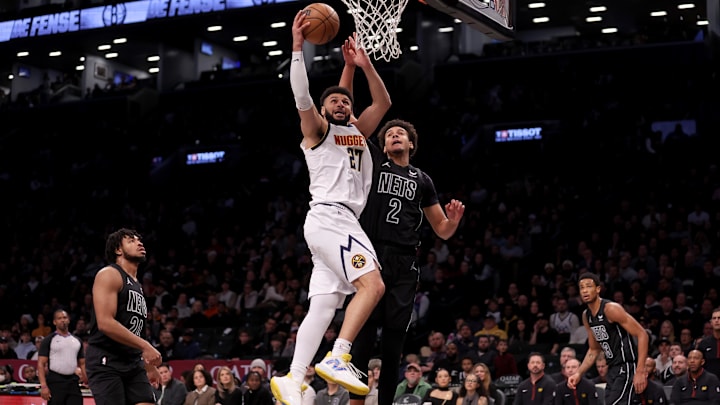 Dec 22, 2023; Brooklyn, New York, USA; Denver Nuggets guard Jamal Murray (27) drives to the basket against Brooklyn Nets forward Cameron Johnson (2) and guard Cam Thomas (24) and center Nic Claxton (33) during the first quarter at Barclays Center. Mandatory Credit: Brad Penner-Imagn Images Dec 22, 2023; Brooklyn, New York, USA; Denver Nuggets guard Jamal Murray (27) drives to the basket against Brooklyn Nets forward Cameron Johnson (2) and guard Cam Thomas (24) and center Nic Claxton (33) during the first quarter at Barclays Center. Mandatory Credit: Brad Penner-Imagn Images