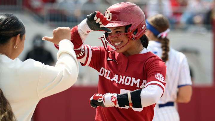 Oklahoma second baseman Ailana Agbayani celebrates after reaching on a single against Kentucky at Love's Field.