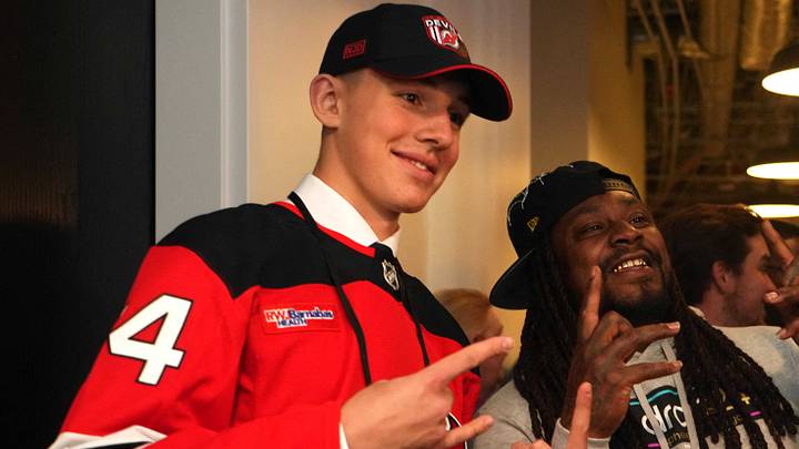 Jun 28, 2024; Las Vegas, Nevada, USA; Former NFL player Marshawn Lynch poses for a photo with New Jersey Devils draft pick Anton Silayev during the 2024 NHL Draft at The Sphere. Mandatory Credit: Joe Camporeale-USA TODAY Sports