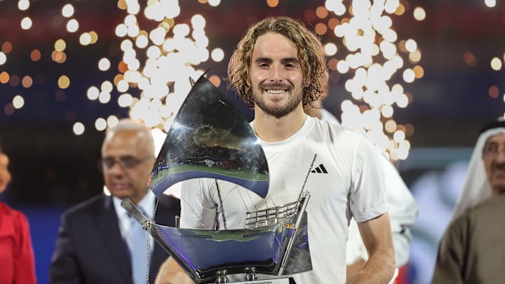 Stefanos Tsitsipas holds the trophy after winning the Dubai Duty Free Tennis Championships.