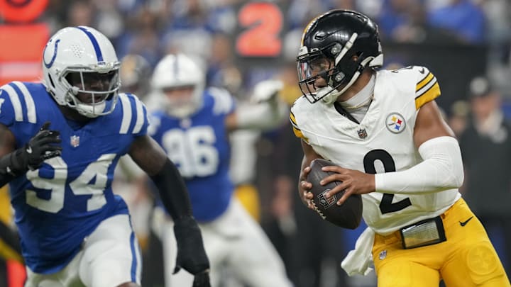 Sep 29, 2024; Indianapolis, Indiana, USA;  Pittsburgh Steelers quarterback Justin Fields (2) scrambles with the ball as Indianapolis Colts defensive end Tyquan Lewis (94) gives chase Sunday, Sept. 29, 2024, during a game at Lucas Oil Stadium in Indianapolis. Mandatory Credit: Grace Smith-USA TODAY Network via Imagn Images