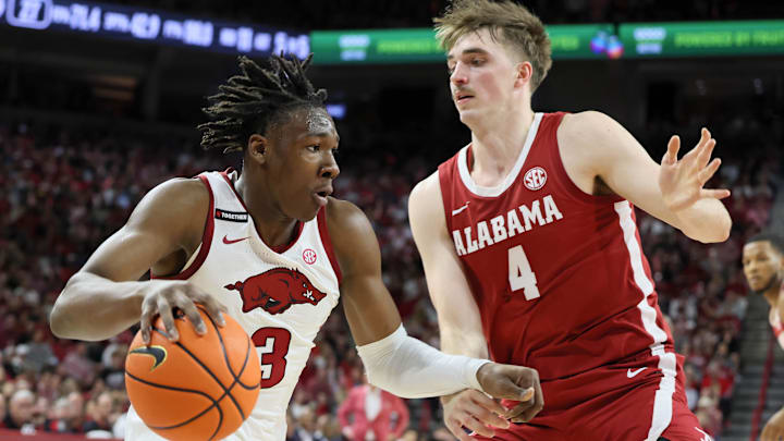 Arkansas Razorbacks forward Adou Thiero (3) drives against Alabama Crimson Tide forward Grant Nelson (4) during the first half at Bud Walton Arena. Arkansas Razorbacks forward Adou Thiero (3) drives against Alabama Crimson Tide forward Grant Nelson (4) during the first half at Bud Walton Arena.