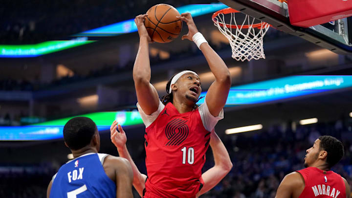Apr 14, 2024; Sacramento, California, USA; Portland Trail Blazers center Moses Brown (10) holds onto a rebound against the Sacramento Kings in the first quarter at the Golden 1 Center. Mandatory Credit: Cary Edmondson-Imagn Images