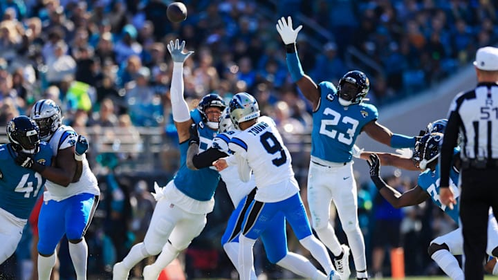 Carolina Panthers quarterback Bryce Young (9) touchback as Jacksonville Jaguars defensive end Roy Robertson-Harris (95) and linebacker Foyesade Oluokun (23) defend during the first quarter of a regular season NFL football matchup Sunday, Dec. 31, 2023 at EverBank Stadium in Jacksonville, Fla. The Jacksonville Jaguars blanked the Carolina Panthers 26-0. [Corey Perrine/Florida Times-Union]
