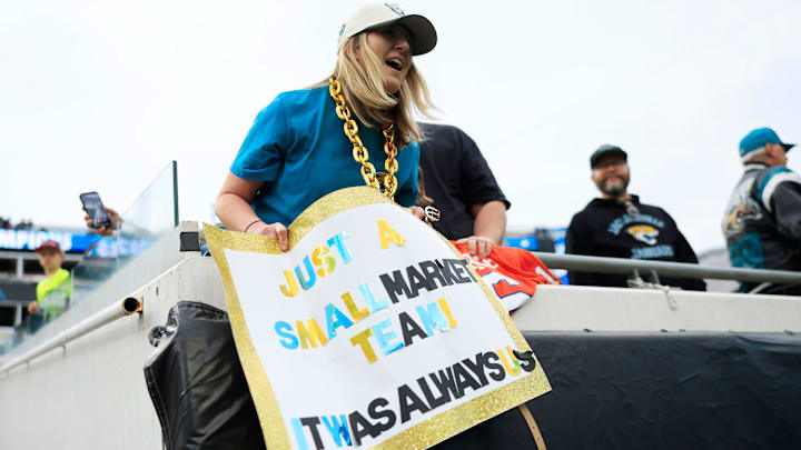Kelsey Christ holds up a sign after the game of an NFL football matchup at EverBank Stadium, Sunday, Jan. 4, 2026, in Jacksonville, Fla. The Jaguars defeated the Titans 41-7, capturing the AFC North title. [Corey Perrine/Florida Times-Union]