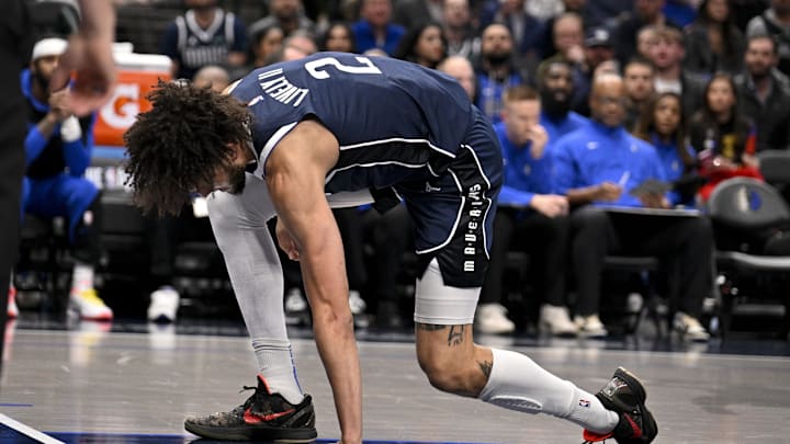 Jan 14, 2025; Dallas, Texas, USA; Dallas Mavericks center Dereck Lively II (2) reacts after suffering a possible leg injury during the first quarter against the Denver Nuggets at the American Airlines Center. Mandatory Credit: Jerome Miron-Imagn Images