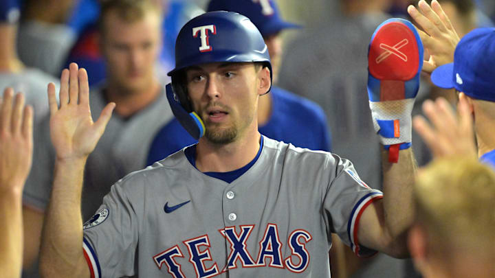 Jul 28, 2025; Anaheim, California, USA; Texas Rangers center fielder Evan Carter (32) in the dugout after scoring a  run in the eighth inning against the Los Angeles Angels at Angel Stadium. 