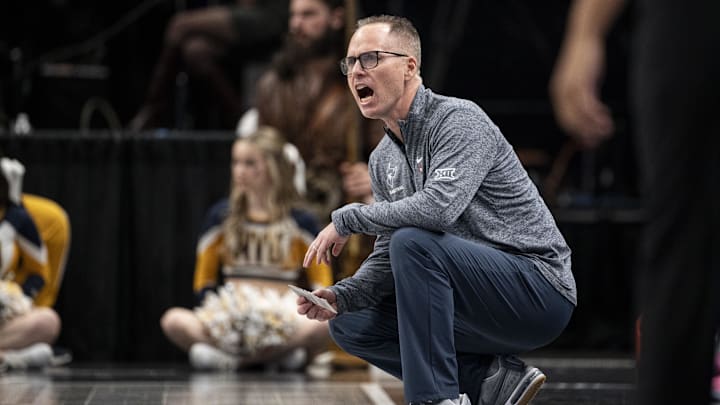 Mar 7, 2025; Kansas City, MO, USA; West Virginia Mountaineers head coach Mark Kellogg looks on from the sideline in the first quarter against the Kansas State Wildcats at T-Mobile Center. Mandatory Credit: Amy Kontras-Imagn Images