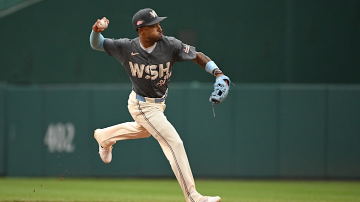Sep 29, 2024; Washington, District of Columbia, USA; Washington Nationals shortstop Nasim Nunez (26) attempts a throw to first base after fielding a ground ball against the Philadelphia Phillies during the third inning at Nationals Park. Sep 29, 2024; Washington, District of Columbia, USA; Washington Nationals shortstop Nasim Nunez (26) attempts a throw to first base after fielding a ground ball against the Philadelphia Phillies during the third inning at Nationals Park.