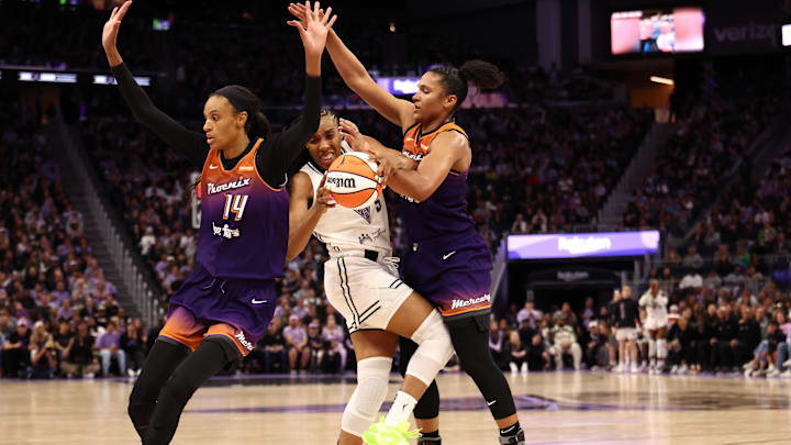 Jul 14, 2025; San Francisco, California, USA; Golden State Valkyries forward Kayla Thornton (5) controls the ball between Phoenix Mercury guard DeWanna Bonner (14) and forward Alyssa Thomas (25) during the fourth quarter at Chase Center. Mandatory Credit: Kelley L Cox-Imagn Images