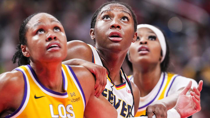 Jun 26, 2025; Indianapolis, Indiana, USA; Indiana Fever forward Aliyah Boston, center, is defended by Los Angeles Sparks forwards Azura Stevens (23) and Rickea Jackson (2) during a free throw in the second half at Gainbridge Fieldhouse. Mandatory Credit: Grace Smith/INDIANAPOLIS STAR-Imagn Images