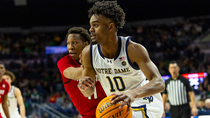 Feb 28, 2026; South Bend, Indiana, USA; Notre Dame Fighting Irish forward Jalen Haralson (10) drives as NC State Wolfpack guard Quadir Copeland (11) defends during the first half at Purcell Pavilion at the Joyce Center. Mandatory Credit: Michael Caterina-Imagn Images