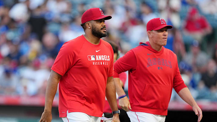 Aug 12, 2025; Anaheim, California, USA; Los Angeles Angels relief pitcher Kenley Jansen (74) receives the Reliever of the Month award from interim manager Ray Montgomery during the game against the Los Angeles Dodgers at Angel Stadium. Mandatory Credit: Kirby Lee-Imagn Images