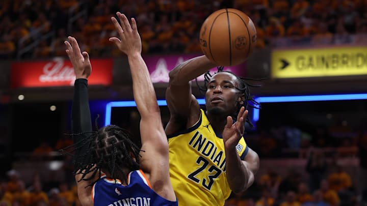 May 25, 2025; Indianapolis, Indiana, USA: Indiana Pacers forward Aaron Nesmith (23) passes around New York Knicks guard Jalen Brunson (11) during the third quarter of game three of the eastern conference finals for the 2025 NBA Playoffs at Gainbridge Fieldhouse. Mandatory Credit: Trevor Ruszkowski-Imagn Images