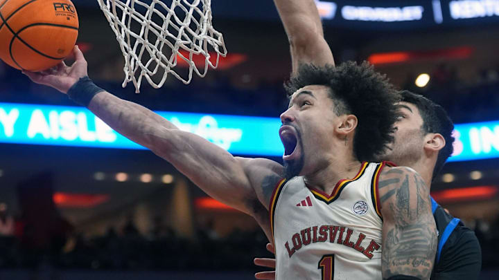Louisville Cardinals guard J'vonne Hadley (1) tries to make the basket against Southern Methodist University Mustangs center Samet Yigitoglu (24) Saturday at the KFC Yum! Center.
Jan. 31, 2026