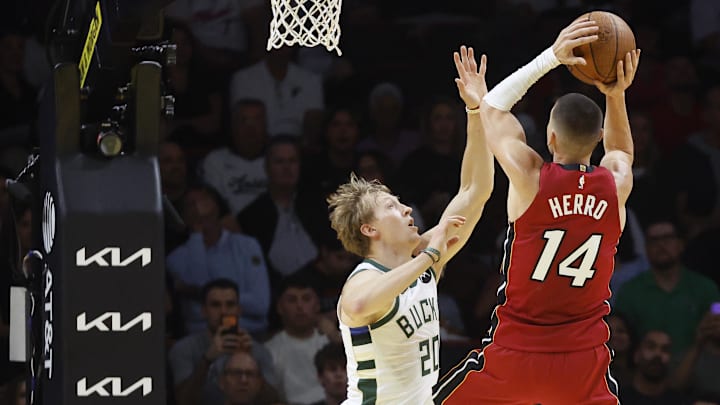 Nov 26, 2025; Miami, Florida, USA; Milwaukee Bucks guard AJ Green (20) defends Miami Heat guard Tyler Herro (14) during the first half of an NBA Cup game at Kaseya Center. Mandatory Credit: Rhona Wise-Imagn Images