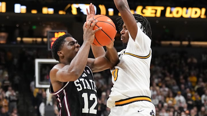 Jan 31, 2026; Columbia, Missouri, USA; Mississippi State Bulldogs guard Josh Hubbard (12) dribbles the ball as Missouri Tigers guard Anthony Robinson II (0) defends during the second half of the game at Mizzou Arena. Mandatory Credit: Denny Medley-Imagn Images