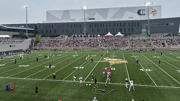 Vikings players warm up before the team's annual night practice. Vikings players warm up before the team's annual night practice.