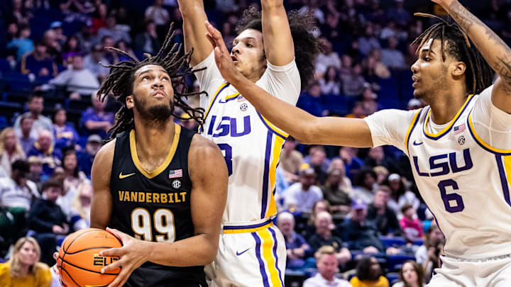 Jan 4, 2025; Baton Rouge, Louisiana, USA;  Vanderbilt Commodores forward Devin McGlockton (99) drives to the basket against LSU Tigers guard Curtis Givens III (3) during the second half at Pete Maravich Assembly Center. Mandatory Credit: Stephen Lew-Imagn Images