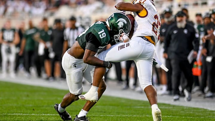 Michigan State's Armorion Smith, left, tackles Central Michigan's DeAnthony Becton during the second quarter on Friday, Sept. 1, 2023, at Spartan Stadium in East Lansing.