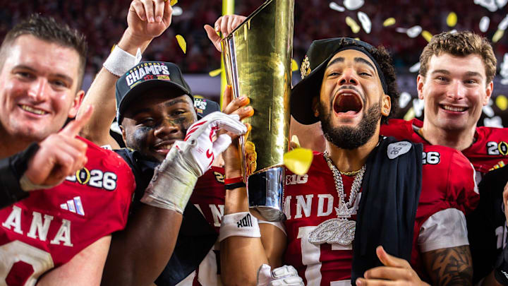 Indiana's Pat Coogan (78), Tyrique Tucker (95), Elijah Sarratt (13) and Fernando Mendoza (15) celebrate with the trophy after the College Football Playoff National Championship college football game at Hard Rock Stadium in Miami Gardens on Monday, Jan. 19, 2026. Indiana's Pat Coogan (78), Tyrique Tucker (95), Elijah Sarratt (13) and Fernando Mendoza (15) celebrate with the trophy after the College Football Playoff National Championship college football game at Hard Rock Stadium in Miami Gardens on Monday, Jan. 19, 2026.