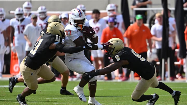 Sep 20, 2025; Blacksburg, Va.; Wofford attempts to tackle Virginia Tech running back Marcellous Hawkins (27) as he runs the ball. Sep 20, 2025; Blacksburg, Va.; Wofford attempts to tackle Virginia Tech running back Marcellous Hawkins (27) as he runs the ball.
