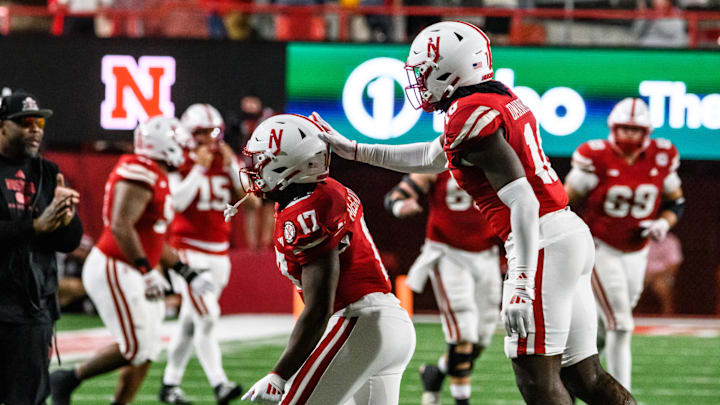 Willis McGahee IV (17) and Princewill Umanmielen celebrate Nebraska’s recovery of a Colorado fumble to secure the win. 