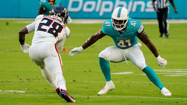Miami Dolphins linebacker Channing Tindall (41) makes a tackle in the first quarter during a preseason game at Hard Rock Stadium on Friday, August 11, 2023, in Miami Gardens, FL.