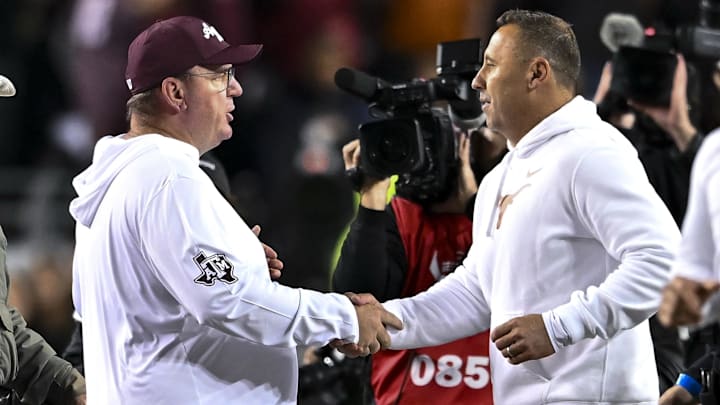 Nov 30, 2024; College Station, Texas, USA; Texas A&M Aggies head coach Mike Elko, left, shakes hands with Texas Longhorns head coach Steve Sarkisian after the game.