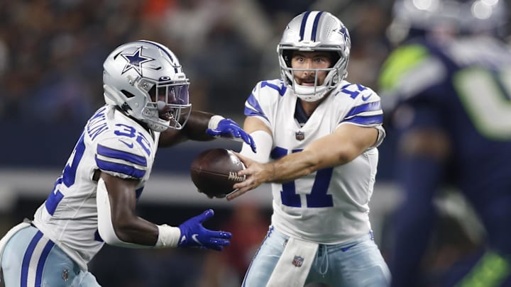 Aug 26, 2022; Arlington, Texas, USA; Dallas Cowboys quarterback Ben DiNucci (17) hands off to running back Aaron Shampklin (32) in the fourth quarter against the Seattle Seahawks at AT&T Stadium. Mandatory Credit: Tim Heitman-Imagn Images