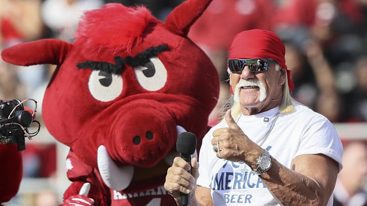 Nov 16, 2024; Fayetteville, Arkansas, USA; Hulk Hogan and an Arkansas Razorbacks mascot hype the crowd during the first quarter against the Texas Longhorns at Donald W. Reynolds Razorback Stadium. Mandatory Credit: Nelson Chenault-Imagn Images