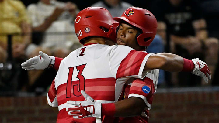 Louisville’s Zion Rose (32) celebrates with Tague Davis (13) after hitting a solo home run against Vanderbilt pitcher Cody Bowker (55) during the fifth inning of the Nashville Regional NCAA Baseball Tournament game at Hawkins Field Saturday, May 31, 2025, in Nashville, Tenn.