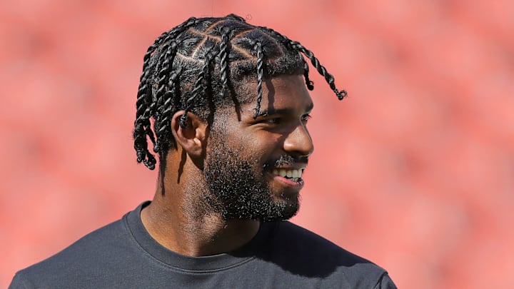 Cleveland Browns quarterback Shedeur Sanders is all smiles as he warms up before an NFL football game at Huntington Bank Field, Sept. 21, 2025, in Cleveland, Ohio.