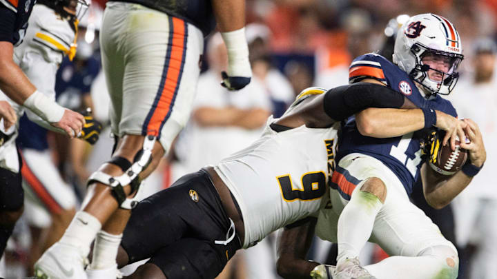 Auburn Tigers quarterback Jackson Arnold (11) is sacked by Missouri Tigers defensive end Zion Young (9) as Auburn Tigers take on Missouri Tigers at Jordan-Hare Stadium in Auburn, Ala. on Saturday, Oct. 18, 2025. Missouri Tigers defeated the Auburn Tigers 23-17 in 2OT.