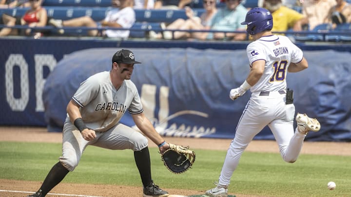 May 25, 2024; Hoover, AL, USA; LSU Tigers outfielder Jake Brown (18) reaches first safely on the green bag as South Carolina Gamecocks utility Ethan Petry (20) covers the white bag during the SEC Baseball Tournament at Hoover Metropolitan Stadium. Mandatory Credit: Vasha Hunt-Imagn Images May 25, 2024; Hoover, AL, USA; LSU Tigers outfielder Jake Brown (18) reaches first safely on the green bag as South Carolina Gamecocks utility Ethan Petry (20) covers the white bag during the SEC Baseball Tournament at Hoover Metropolitan Stadium. Mandatory Credit: Vasha Hunt-Imagn Images