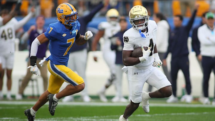 Notre Dame Fighting Irish running back Jeremiyah Love (4) rushes downfield while being trailed by Pittsburgh Panthers defensive back Javon McIntyre (7) during the first half at Acrisure Stadium in Pittsburgh, PA on November 15, 2025. Notre Dame Fighting Irish running back Jeremiyah Love (4) rushes downfield while being trailed by Pittsburgh Panthers defensive back Javon McIntyre (7) during the first half at Acrisure Stadium in Pittsburgh, PA on November 15, 2025.