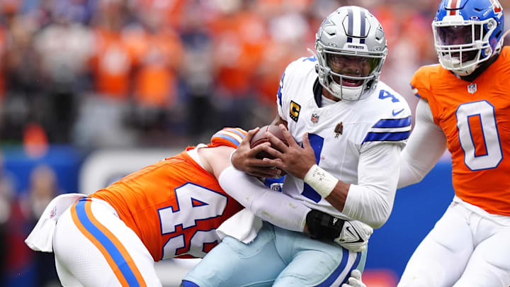 Denver Broncos linebacker Alex Singleton tackles Dallas Cowboys quarterback Dak Prescott. Denver Broncos linebacker Alex Singleton tackles Dallas Cowboys quarterback Dak Prescott.