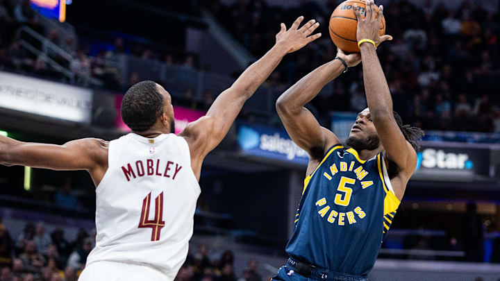 Jan 14, 2025; Indianapolis, Indiana, USA;  Indiana Pacers forward Jarace Walker (5) shoots the ball while Cleveland Cavaliers forward Evan Mobley (4) defends in the second half at Gainbridge Fieldhouse. Mandatory Credit: Trevor Ruszkowski-Imagn Images